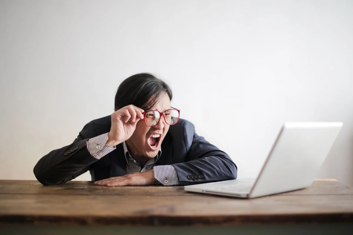 Man frustrated at a laptop — representing the struggle of finding the right freelancer