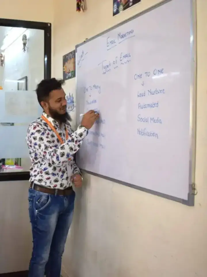 Shezad Ali Khan teaching at a whiteboard