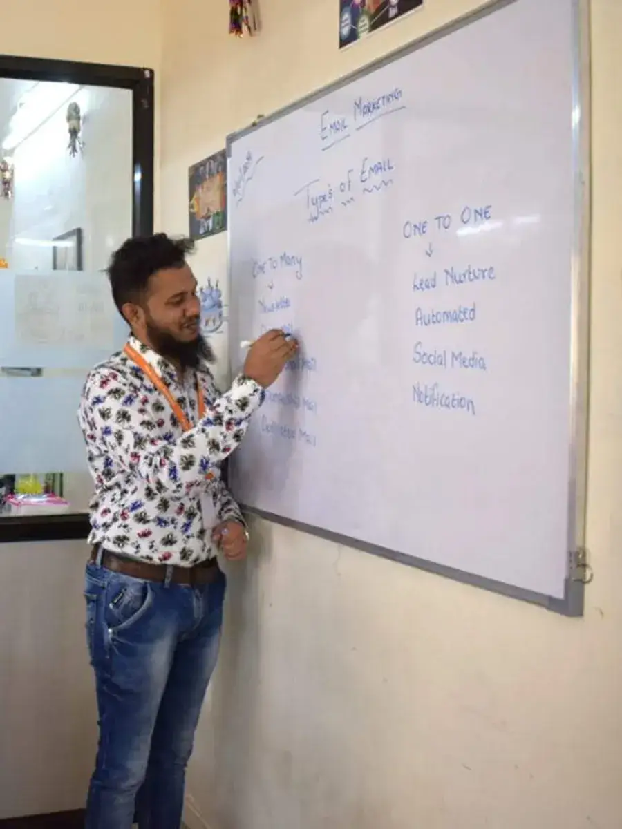 Shezad Ali Khan teaching at a whiteboard