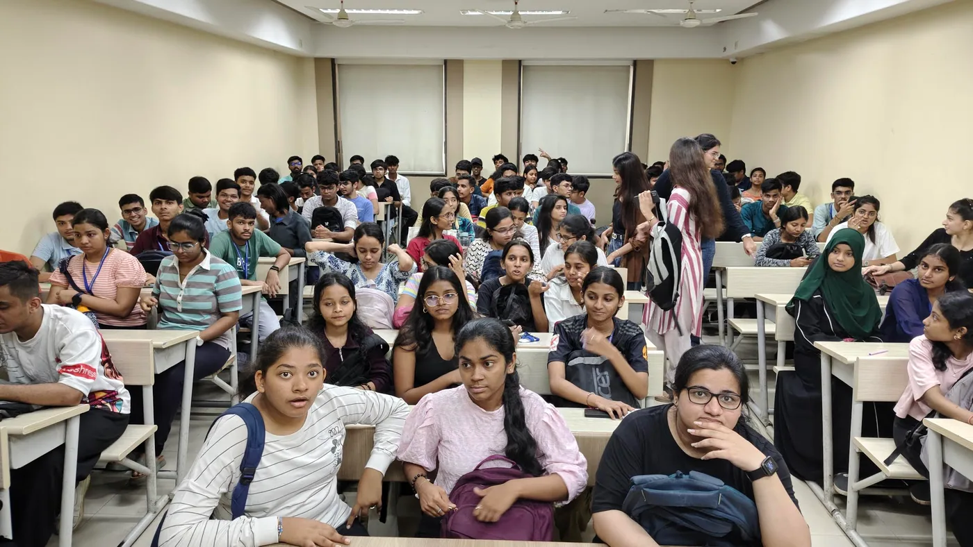 Shezad speaking to a packed college audience, 2024