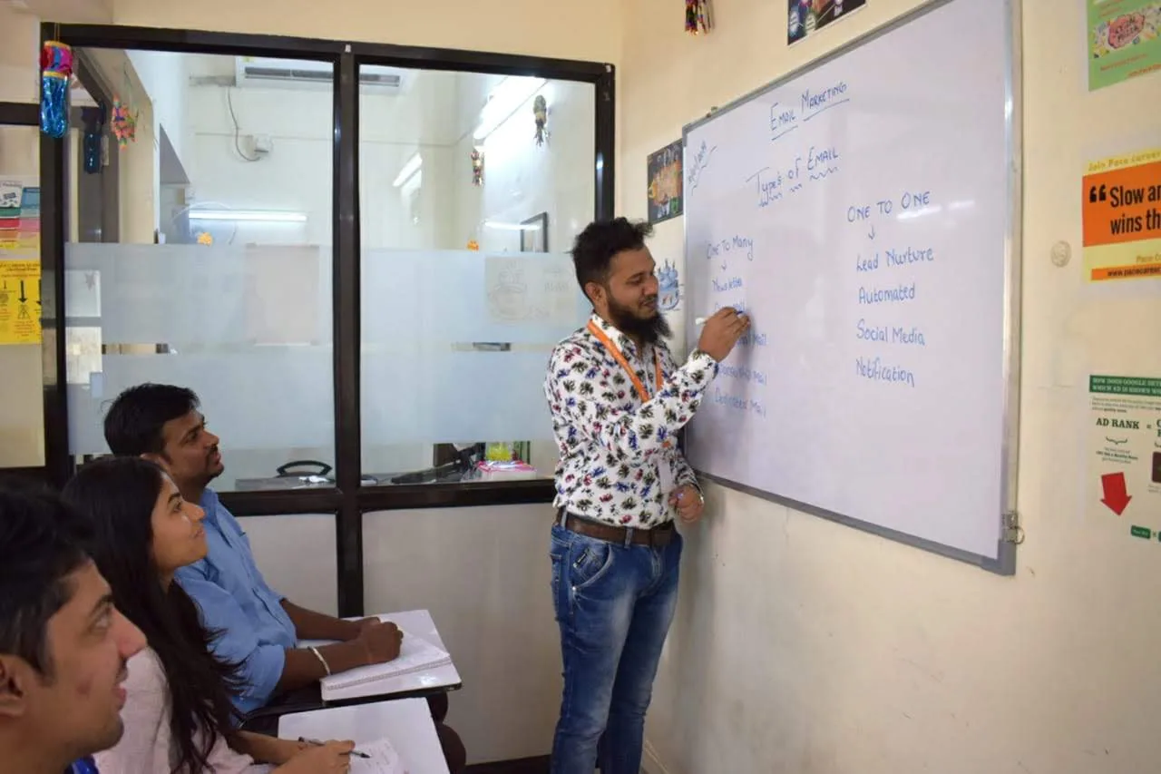 Shezad teaching email marketing at a whiteboard